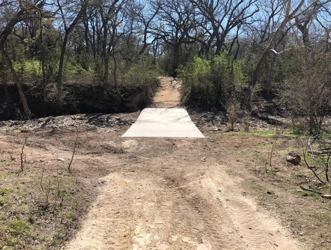 Concrete slab crossing installed over a creek approach