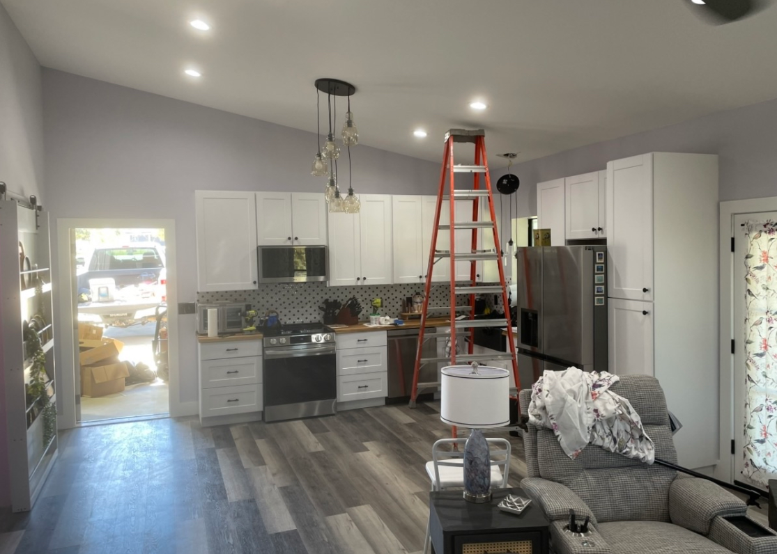 Finished kitchen with white shaker cabinets and stainless appliances