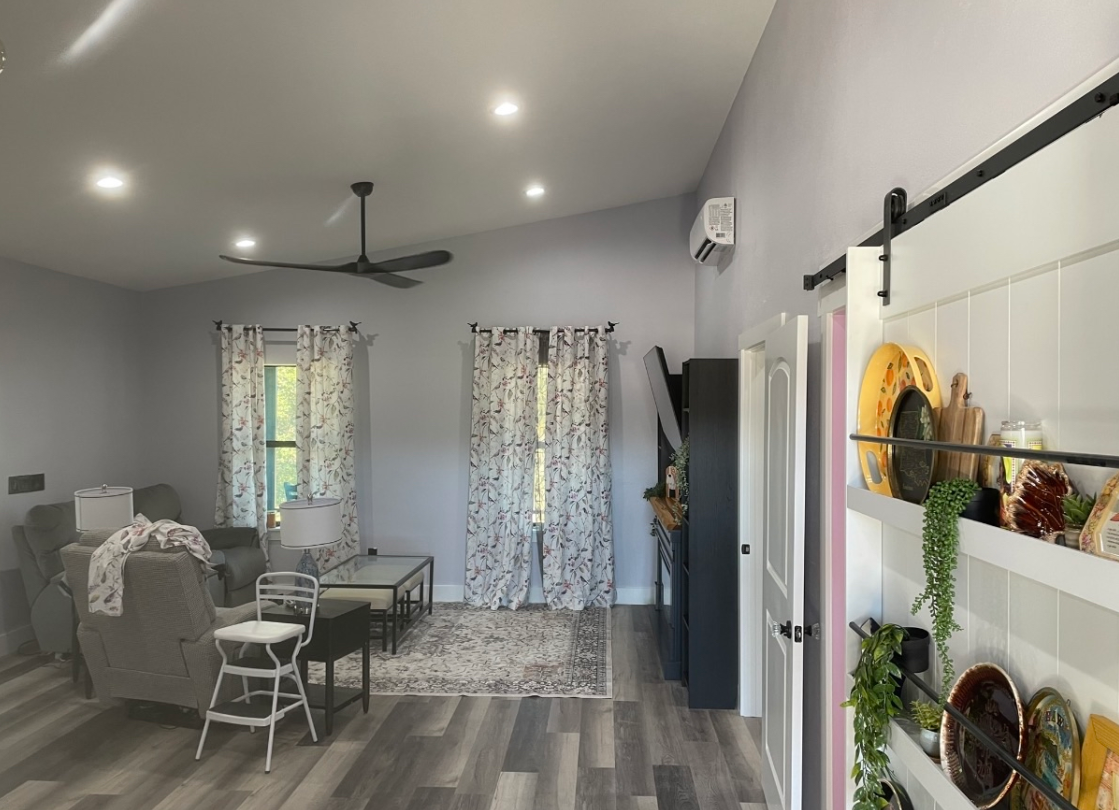 Finished open-concept living room with vaulted ceilings