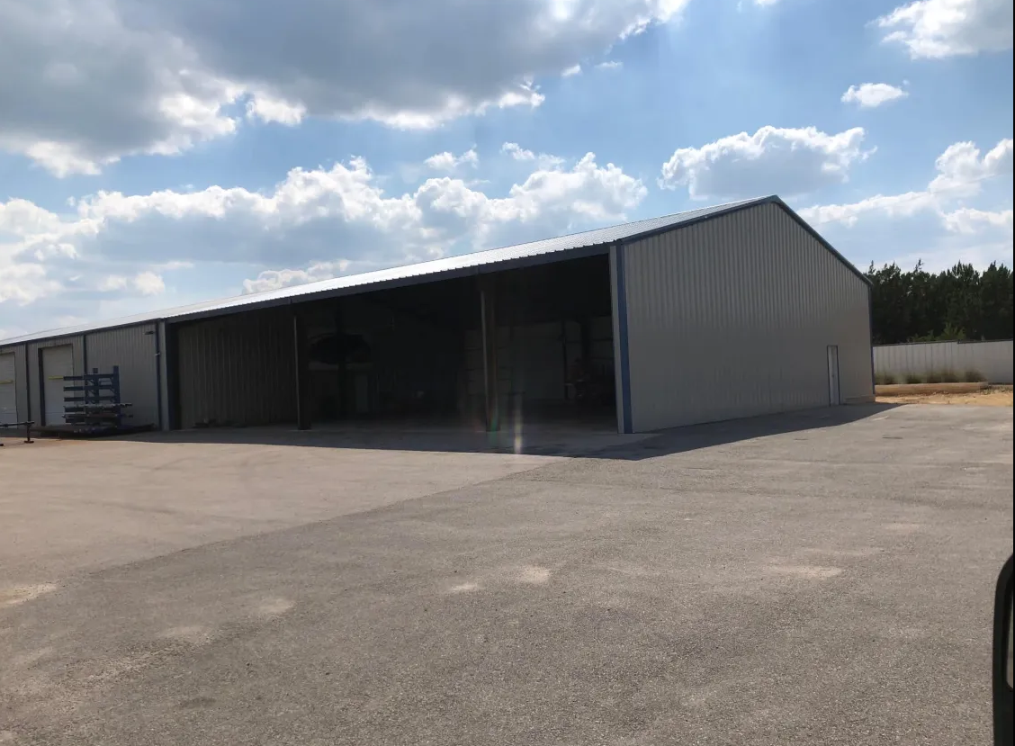Large open-bay metal warehouse on concrete pad