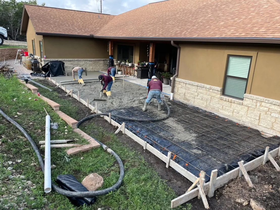 Crew finishing a residential patio pour