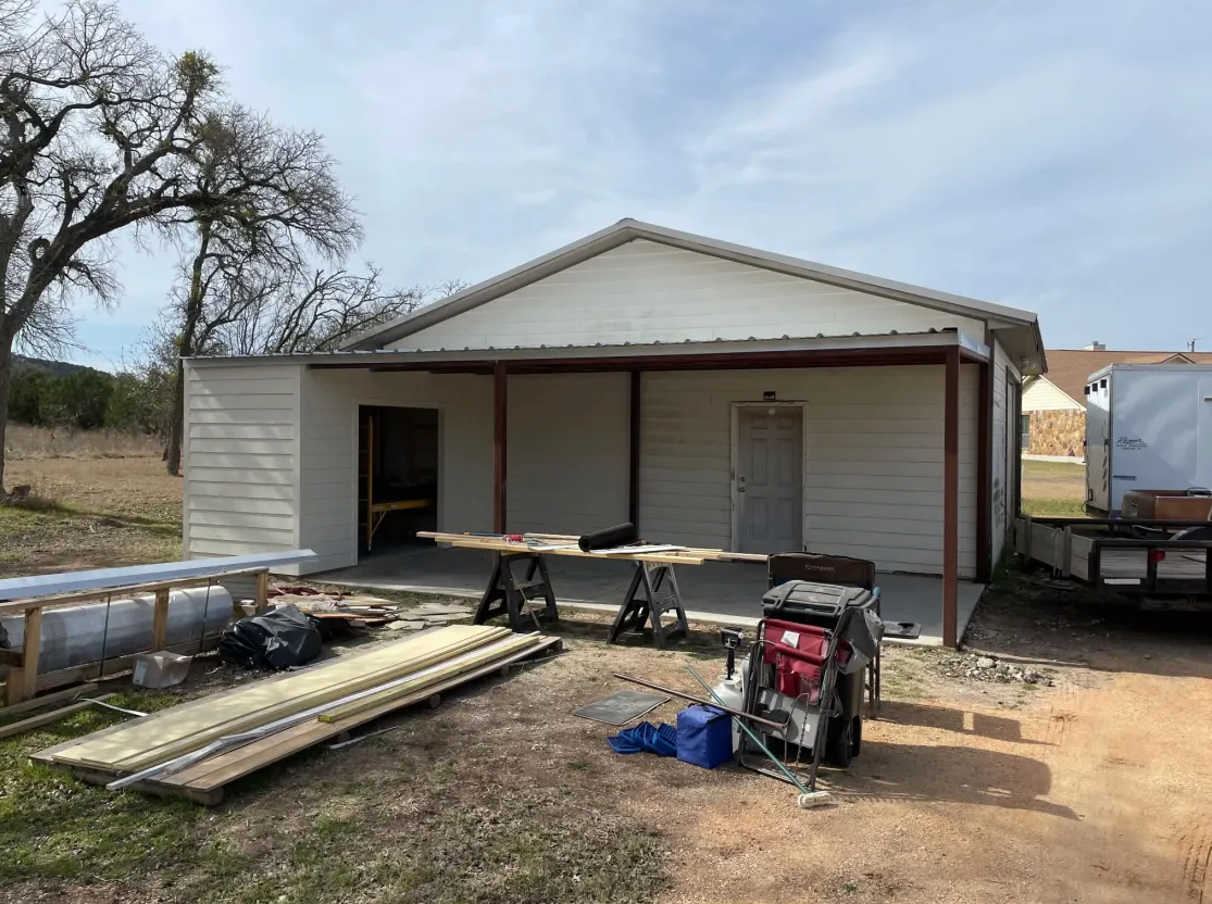 Workshop with covered porch and concrete pad