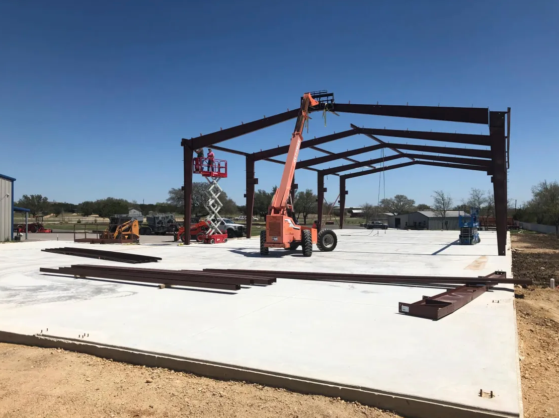 Steel structure going up over a commercial slab